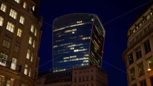 View of the Walkie-Talkie skyscraper standing tall above surrounding architecture in the evening, London, England - Starpik Stock