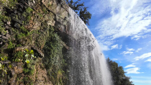 View of the waterfall at Castle Hill in Nice, France with clear water cascading down the rocks - Starpik Stock