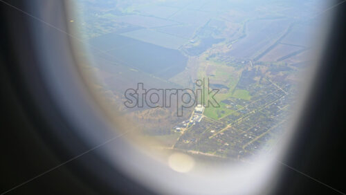 View of towns and fields in Moldova from an airplane window - Starpik Stock