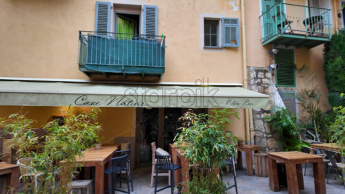 Villefranche-sur-Mer, France – July 18, 2025: View of greenery on the streets of the city lined with colourful buildings - Starpik Stock