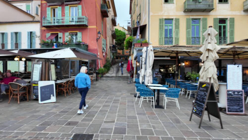 Villefranche-sur-Mer, France – July 18, 2025: View of terraces on the streets of the city lined with colourful buildings - Starpik Stock