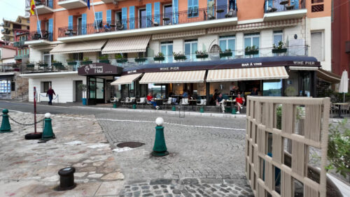 Villefranche-sur-Mer, France – July 18, 2025: View of the city lined with colourful buildings on the shore of the sea - Starpik Stock