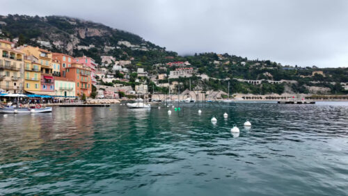 Villefranche-sur-Mer, France – July 18, 2025: View of the city lined with colourful buildings on the shore of the sea - Starpik Stock