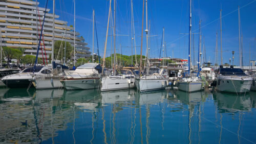 Villeneuve-Loubet, France – June 7, 2025: Boats docked in the Marina Baie des Anges in daylight - Starpik Stock