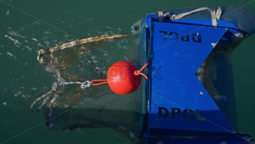 Villeneuve-Loubet, France – June 7, 2025: Close up of a floating marine debris collection device in the water - Starpik Stock