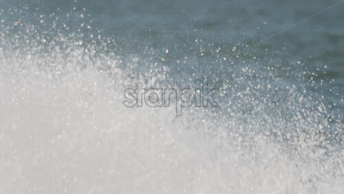 Water being splashed around by a jet ski moving at high speed across a calm body of water - Starpik Stock