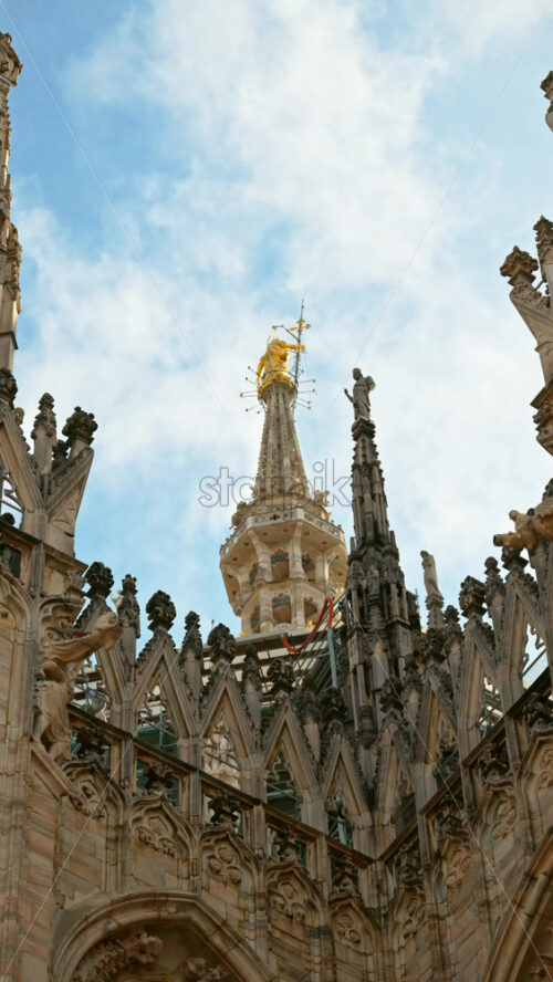 Zoom shot of the details on Duomo Cathedral in Milan, Italy. Vertical - Starpik Stock