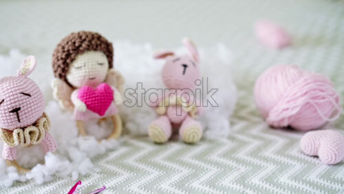 Video - Cute knitted plush toys on the sofa with plush around them