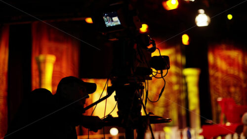 Video - Chisinau, Moldova - March 29, 2024: Man filming with professional camera on the backstage of a TV set