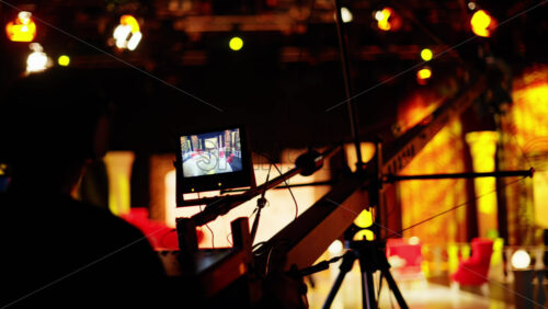 Video - Man filming with professional camera on the backstage of a TV set