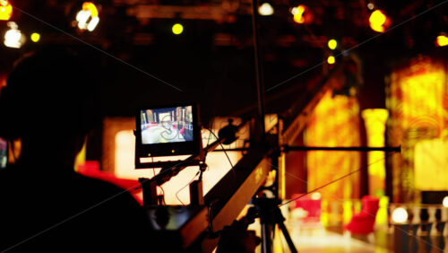 Video - Man filming with professional camera on the backstage of a TV set