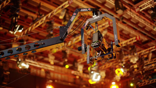Video - Chisinau, Moldova - March 29, 2024: Professional camera filming and flashing studio lights on the ceiling of a TV set