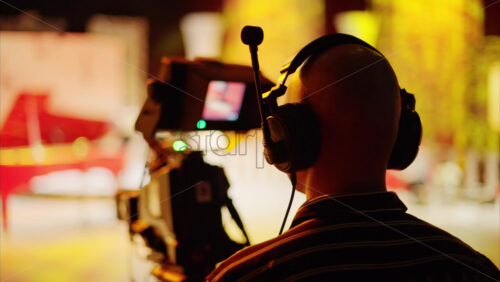 Video - Man filming with professional camera on the backstage of a TV set