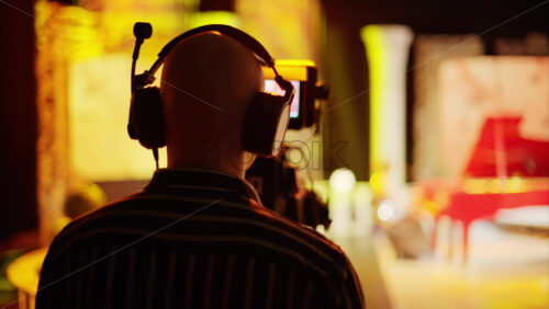 Video - Man filming with professional camera on the backstage of a TV set