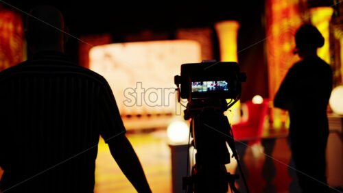 Video - Chisinau, Moldova - March 29, 2024: Man filming with professional camera on the backstage of a TV set