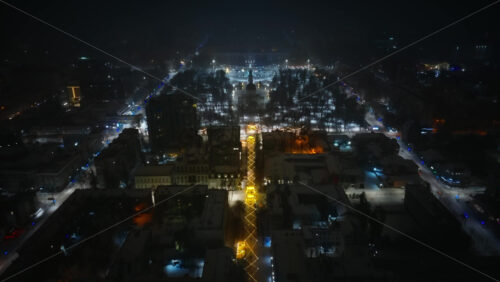 Video - Aerial drone view of Chisinau center city covered in snow. Cathedral and Government building at night. Moldova
