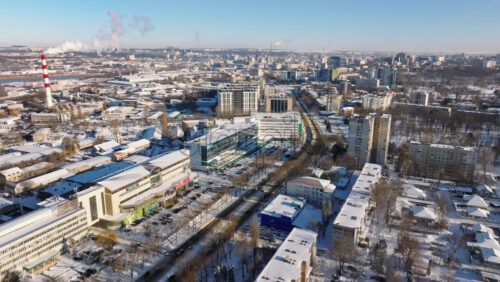 Video - Chisinau, Moldova - January 10, 2024: Aerial drone view of the city covered in snow. Sunrise during winter