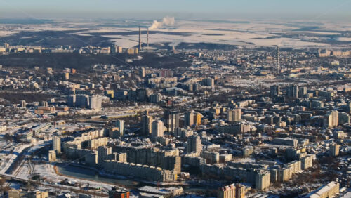Video - Aerial drone view of Chisinau city covered in snow at sunrise. Working thermal power station in background. Winter in Moldova