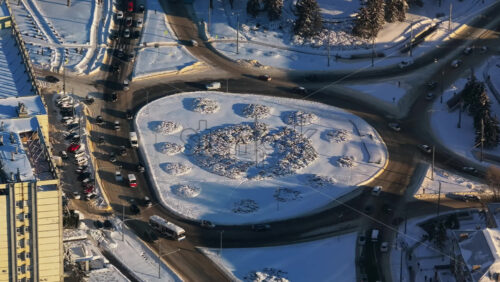 Video - Aerial drone view of the city covered in snow with moving traffic. Sunrise during winter in Chisinau, Moldova