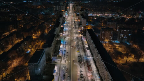 Video - Aerial drone view of Chisinau city covered in snow at night, blue hour. Moldova