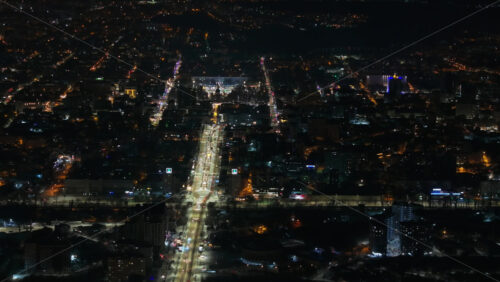 Video - Aerial drone view of Chisinau city covered in snow at night, blue hour. Moldova