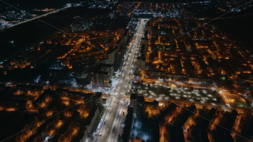 Video - Aerial drone view of Chisinau city covered in snow at night, blue hour. Moldova