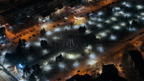 Video - Aerial drone view of Chisinau city covered in snow at night, blue hour. Moldova