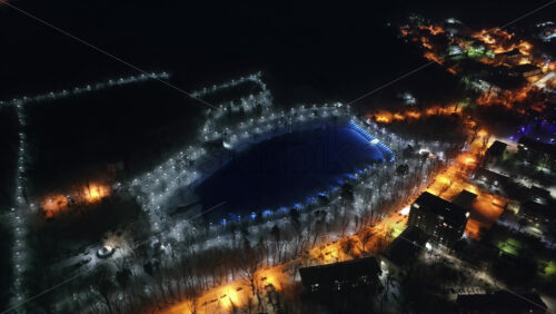 Video - Aerial drone view of Chisinau city covered in snow at night, blue hour. Moldova