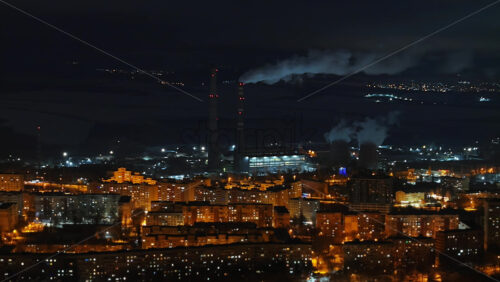 Video - Aerial drone view of Chisinau city covered in snow at night, blue hour. Moldova