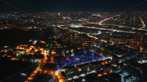 Video - Aerial drone view of Chisinau city covered in snow at night, blue hour. Moldova