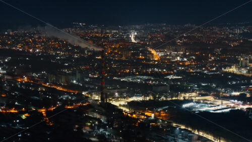 Video - Aerial drone view of Chisinau city covered in snow at night, blue hour. Moldova