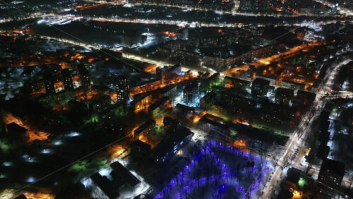 Video - Aerial drone view of Chisinau city covered in snow at night, blue hour. Moldova