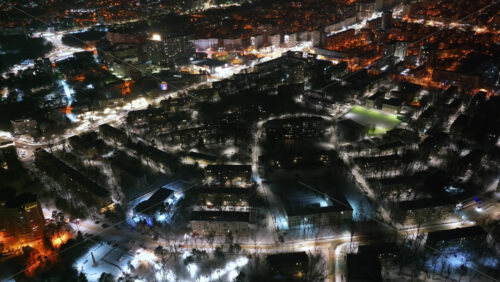 Video - Aerial drone view of Chisinau city covered in snow at night, blue hour. Moldova