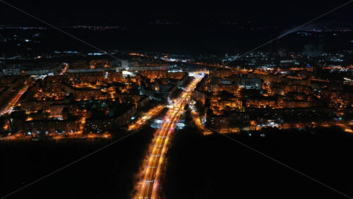 Video - Aerial drone view of Chisinau city covered in snow at night, blue hour. Moldova