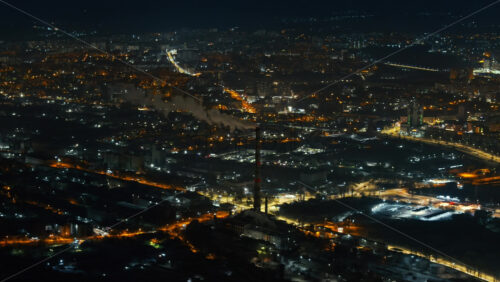 Video - Aerial drone view of Chisinau city covered in snow at night, blue hour. Moldova