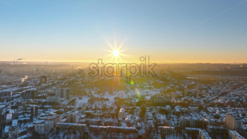 Video - Aerial drone view of the city covered in snow. Sunrise during winter in Chisinau, Moldova