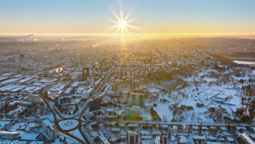 Video - Aerial drone view of the city covered in snow. Sunrise during winter in Chisinau, Moldova