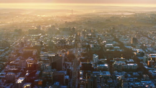 Video - Aerial drone view of the city center covered in snow. Sunrise during winter in Chisinau, Moldova