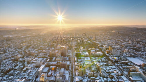 Video - Aerial drone view of the city covered in snow. Sunrise during winter in Chisinau, Moldova
