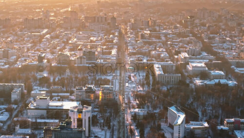 Video - Aerial drone view of the city covered in snow. The Presidential Palace and the Parliament in the city center. Sunrise during winter in Chisinau, Moldova