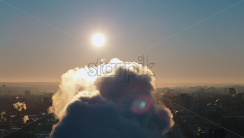 Video - Aerial drone view of a working thermal power station in Chisinau at sunset. Steam and smoke coming from pipes. Moldova