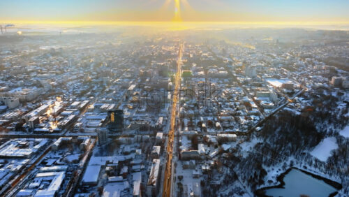 Video - Aerial drone view of the city covered in snow. Sunrise during winter in Chisinau, Moldova