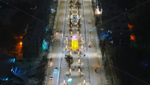 Video - Aerial drone view of Chisinau city covered in snow at night, blue hour. Moldova