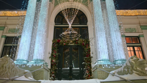 Video - Organ Hall entrance with Christmas decorations during snowfall. Winter evening in Chisinau, Moldova