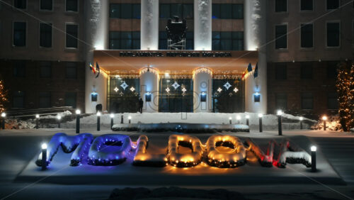 Video - Parliament of the Republic of Moldova with national emblem, illumination and Christmas decorations in the evening. Ground covered in snow. Winter in Chisinau