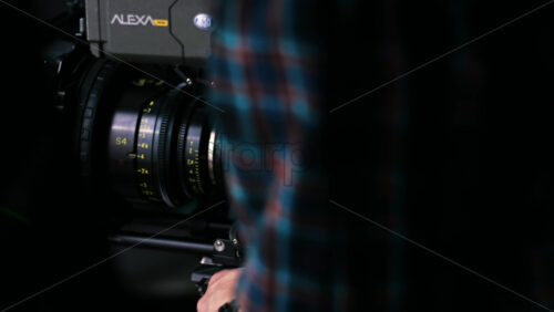 Video - CHISINAU, MOLDOVA - MARCH 28, 2021: Man removing professional Arri video camera from a tripod on the movie set