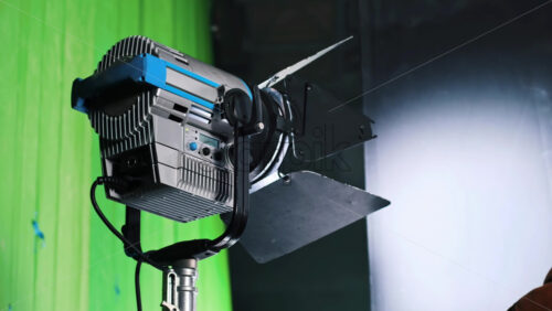 Video - Professional lighting equipment on the movie set with a man rotating a plate