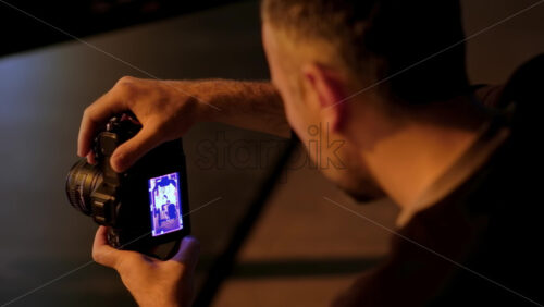 Video - Chisinau, Moldova - March 29, 2024: Man taking vertical video with professional camera on the backstage of a TV set