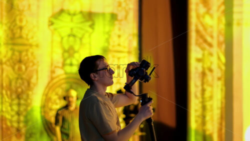 Video - Chisinau, Moldova - March 29, 2024: Man filming with professional camera on the backstage of a TV set