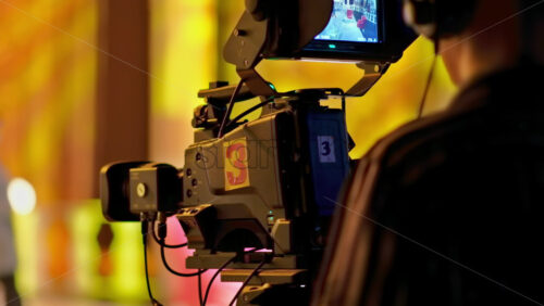 Video - Man filming with professional camera on the backstage of a TV set